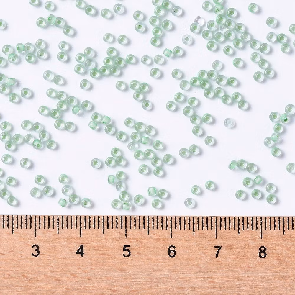 Toho 11/0 ( 975 ) inside color crystal/neon sea foame lined 11/0, 10gram