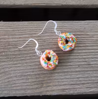 Earrings, donuts with pink icing and sprinkles without a bite