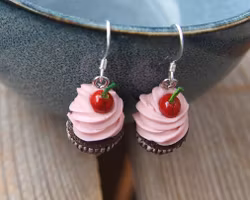 Earrings, chocolate cupcakes with pink frosting and cherries.