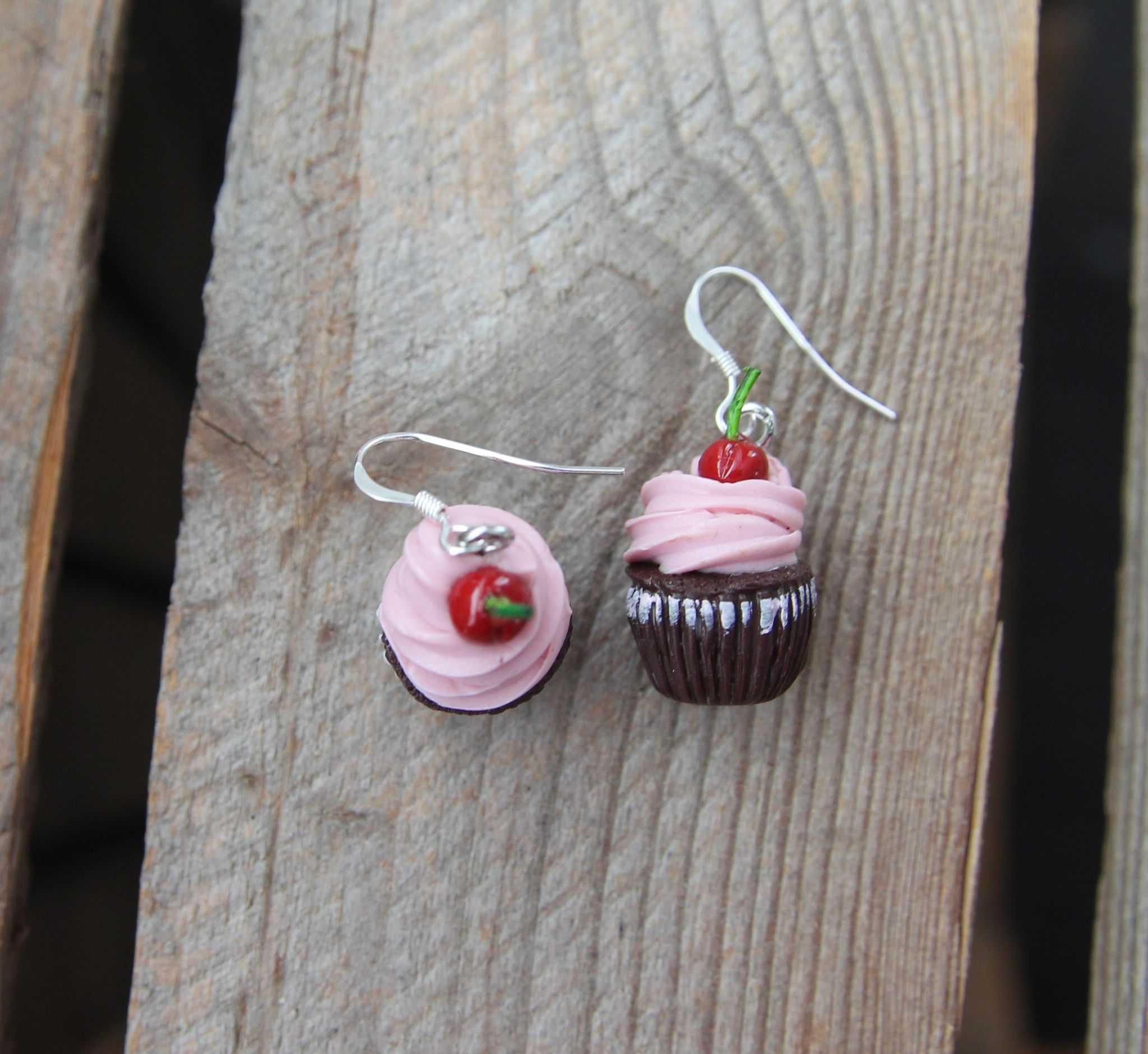Örhängen, chokladcupcakes med rosa frosting och körsbär.