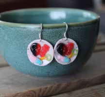 Earrings, blue coffee plates with vacuum cleaner, chocolate ball and cinnamon bun
