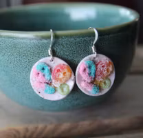 Earrings, blue coffee plates with vacuum cleaner, chocolate ball and cinnamon bun