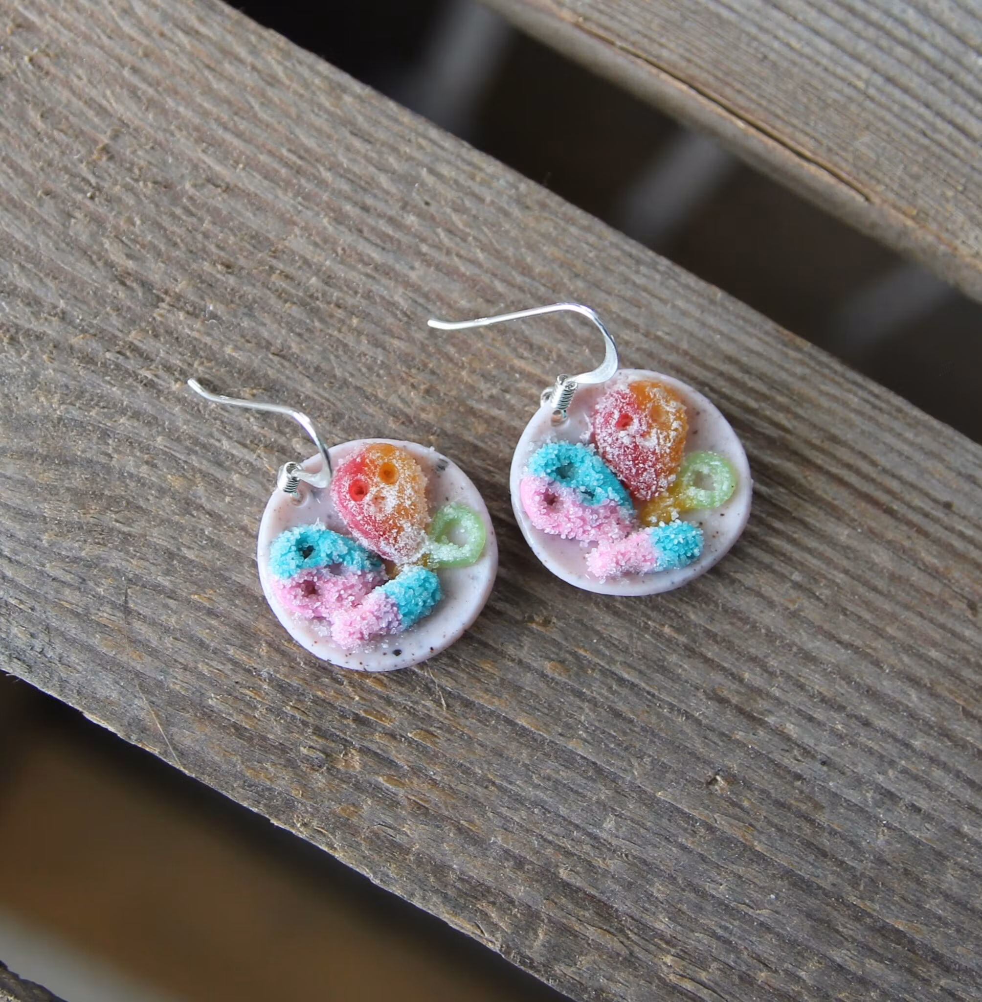 Earrings, blue coffee plates with vacuum cleaner, chocolate ball and cinnamon bun
