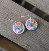 Earrings, blue coffee plates with vacuum cleaner, chocolate ball and cinnamon bun