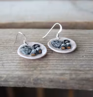 Earrings, blue coffee plates with vacuum cleaner, chocolate ball and cinnamon bun