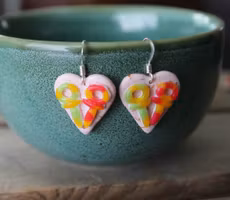 Earrings, blue coffee plates with vacuum cleaner, chocolate ball and cinnamon bun