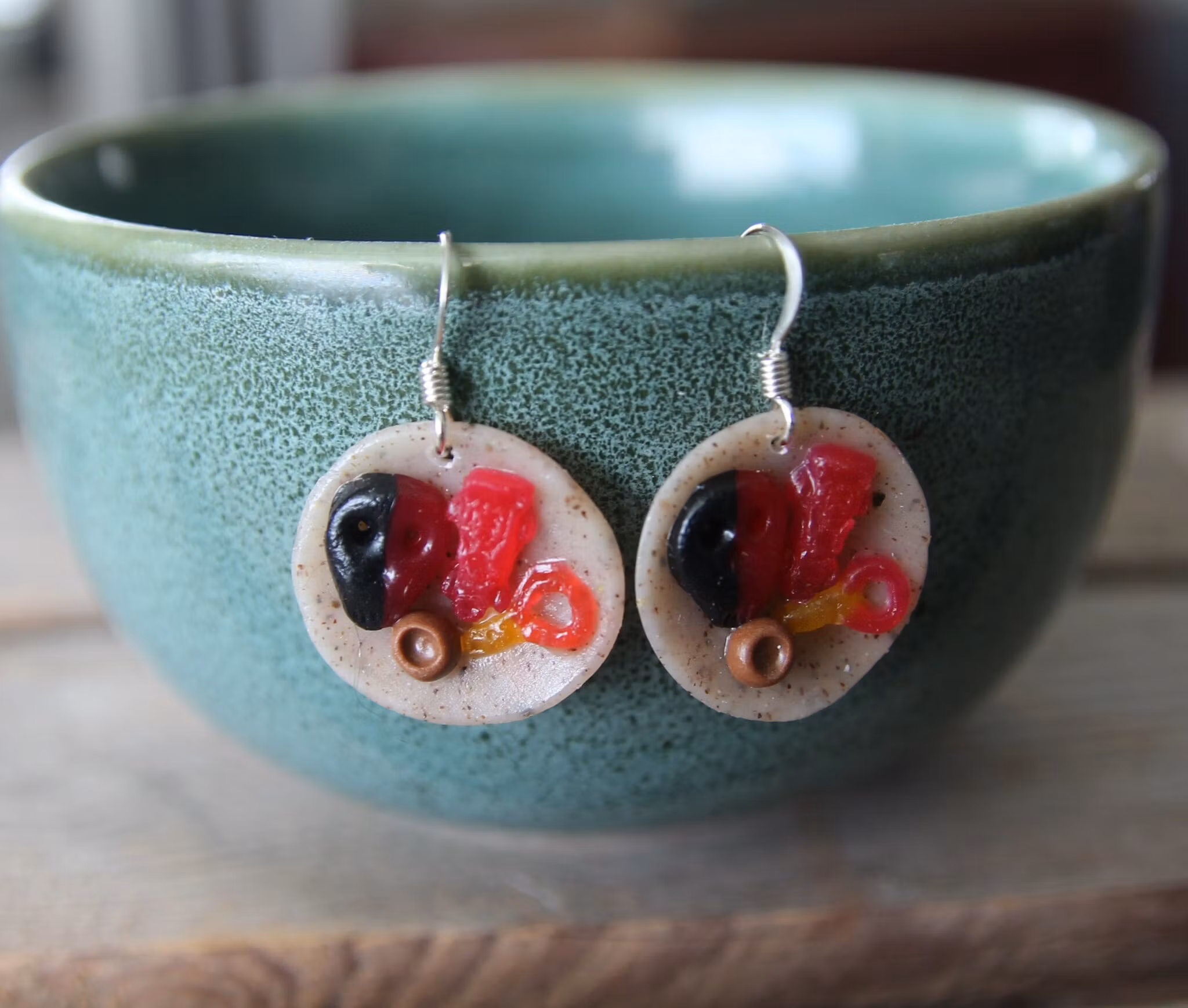 Earrings, blue coffee plates with vacuum cleaner, chocolate ball and cinnamon bun