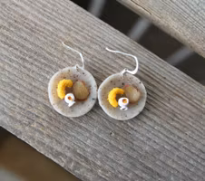 Earrings, blue coffee plates with vacuum cleaner, chocolate ball and cinnamon bun