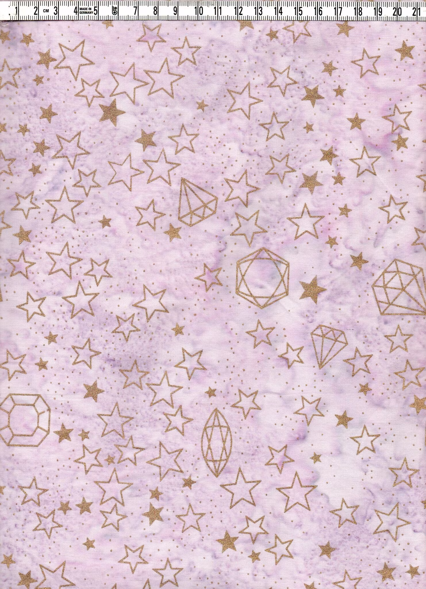 Ljust violettflammig med guldstjärnor. Bomull. Bredd ca 110 cm