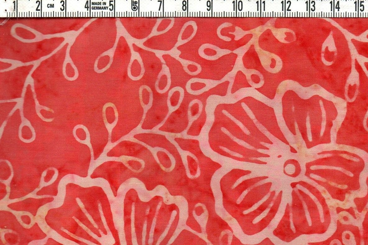 Läckert laxorange med ljusare blommor. Bomull 110 cm.