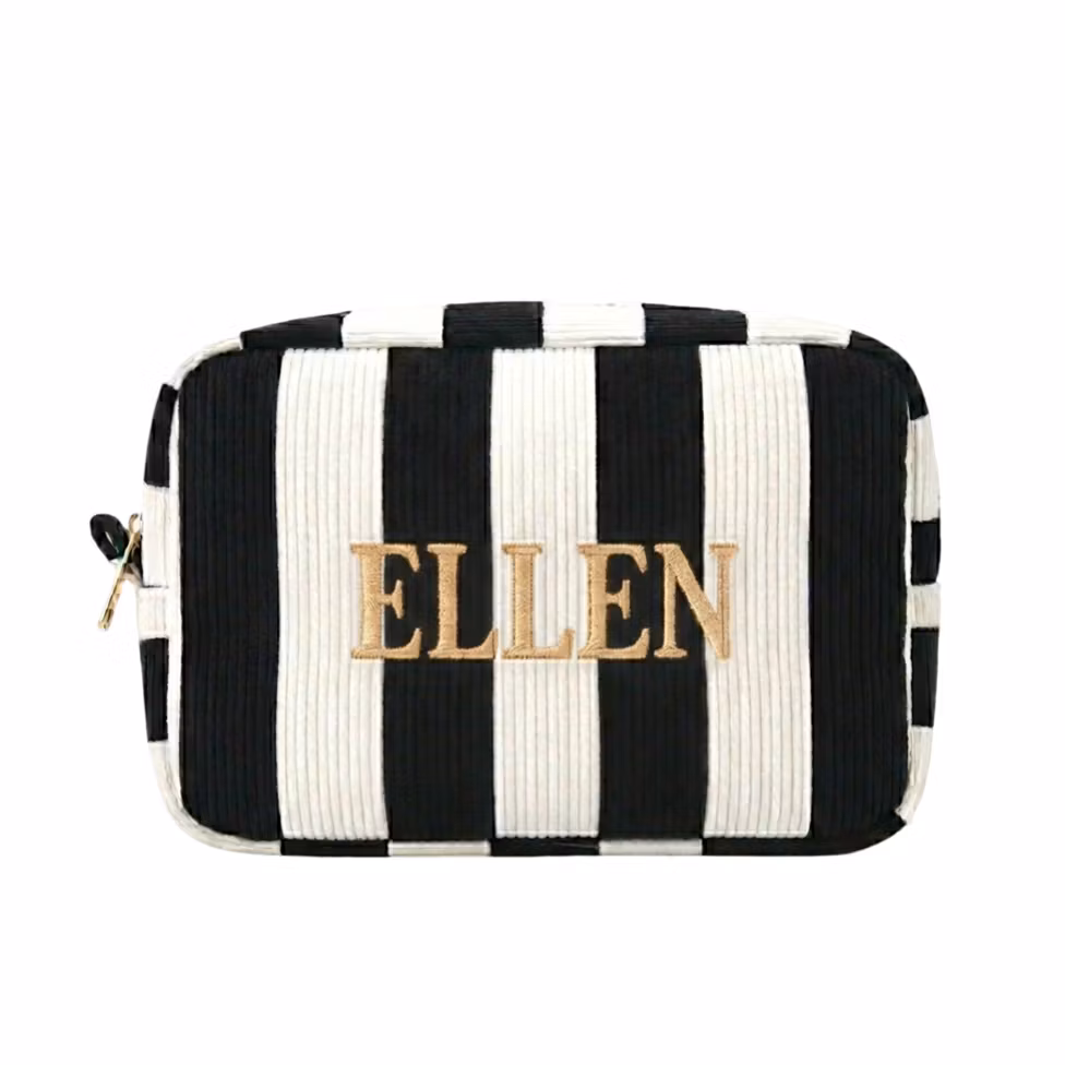 Randig vit/svart sminkväska med namn