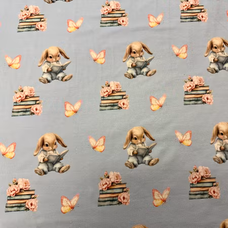 Kaniner med böcker och fjärilar, ljusblå bakgrund Bomullsjersey