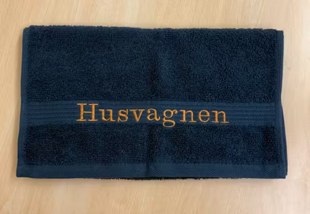 Gästhandduk med broderad text "Husvagnen"
