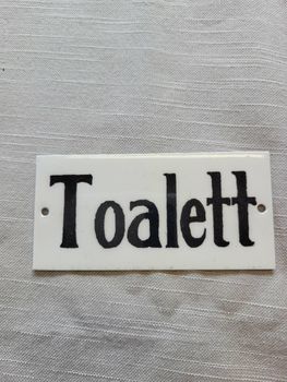 Skylt Toalett