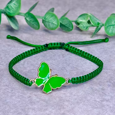 Somrigt armband med en grön fjäril