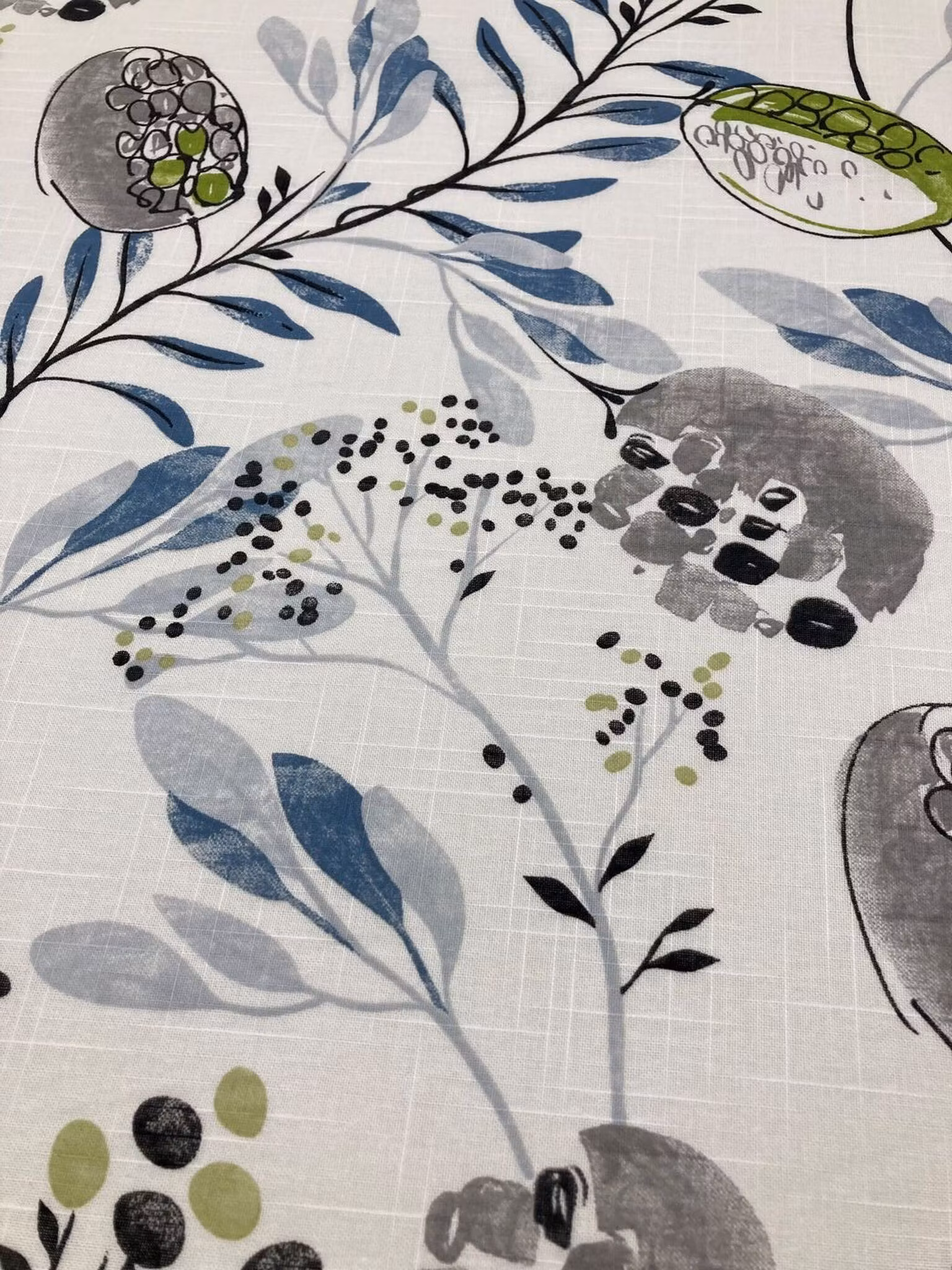 Närbild av Morgonbris tyg med botaniskt mönster i blå gröna och grå toner