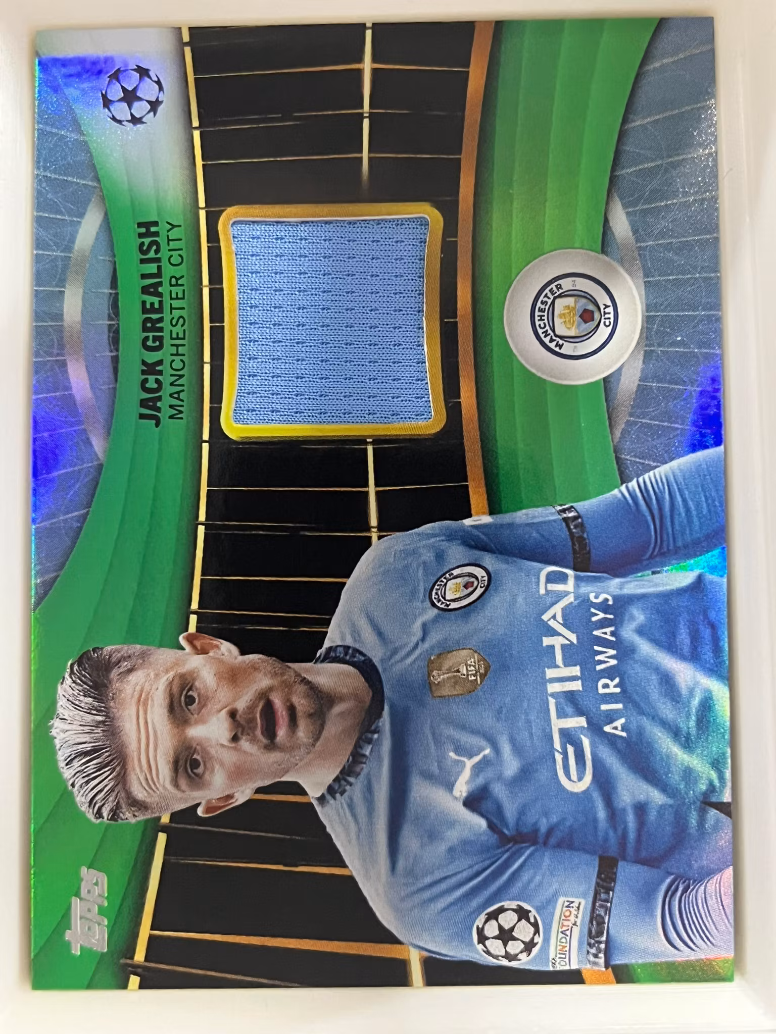 2024-25 Topps UEFA Club Competitions Relics Green Foilboard #SRJG Jack Grealish (100-II11-SOCCERMANCHESTERCITY)