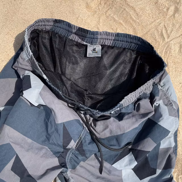 The black inner lining netting shown on a pair of POSEIDON Swim Shorts M90