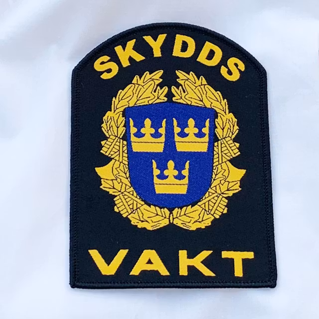 Skyddsvakt Rundad Tygmärke närbild