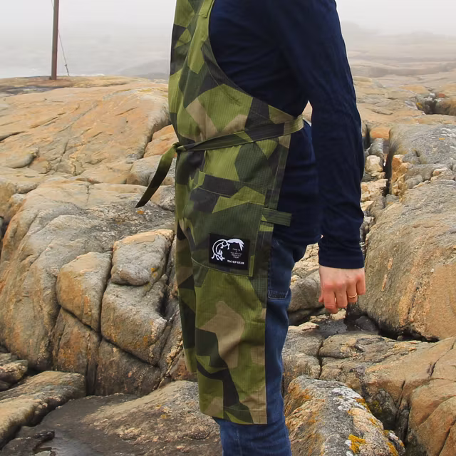 With stone background wearing a Apron M90.