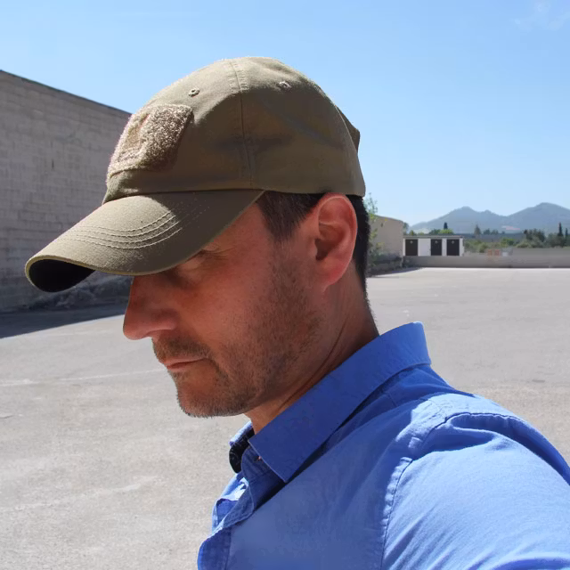 Shading from the sun under a Baseball Cap Coyote.