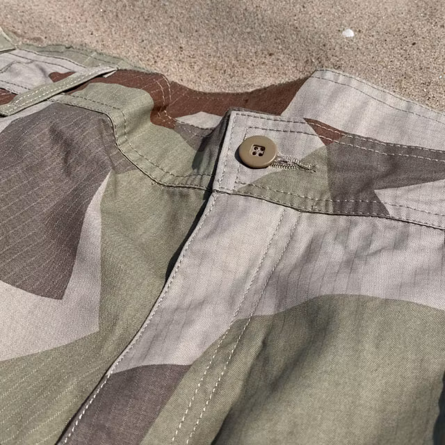 Waist button on a pair of Camp Shorts M90K Desert