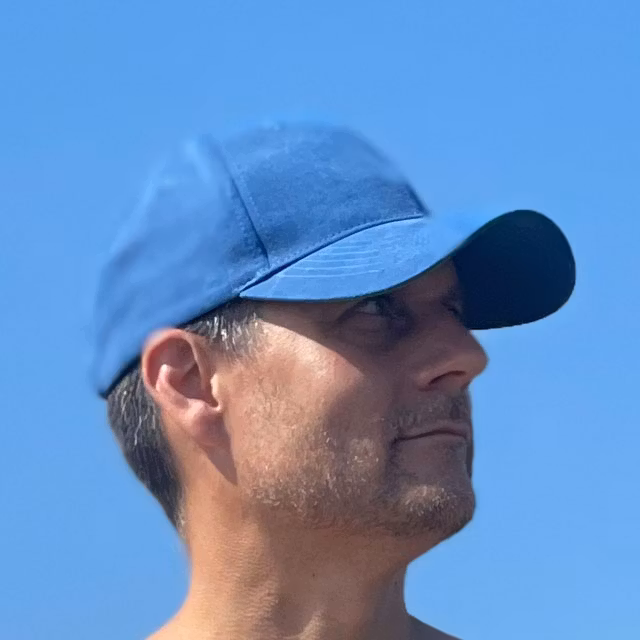 Baseball Cap Blue on the beach seen from the right and worn by model