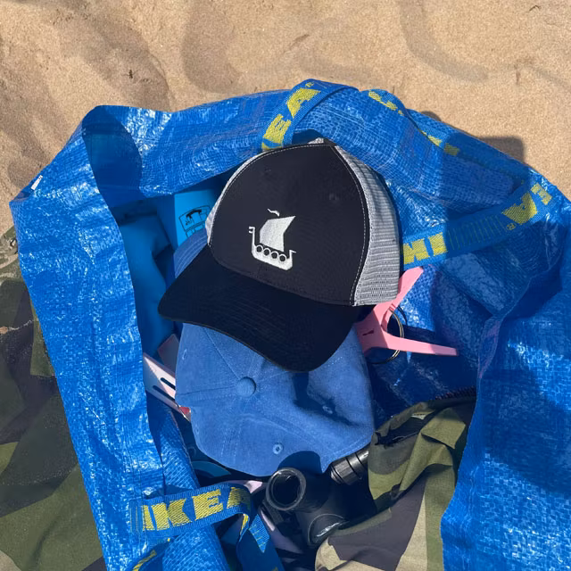 Mesh Cap Black and Grey on the beach in a IKEA bag