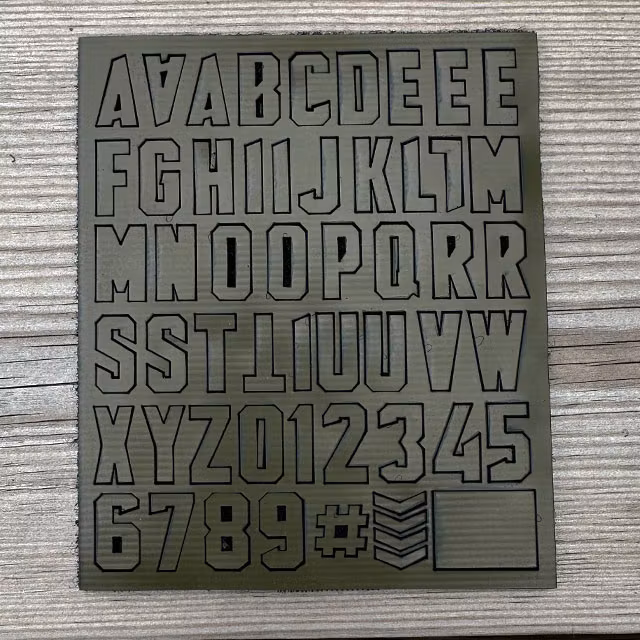 DIY Alphabet and Number Hook Patch Set Green displayed on a wooden surface