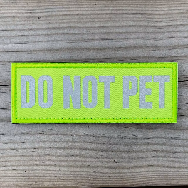 Do Not Pet HiVis Patch displayed on a wooden surface