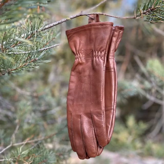 A pair of Bushcraft Leather Glove Brown from TAC-UP GEAR hanged up in their hangers