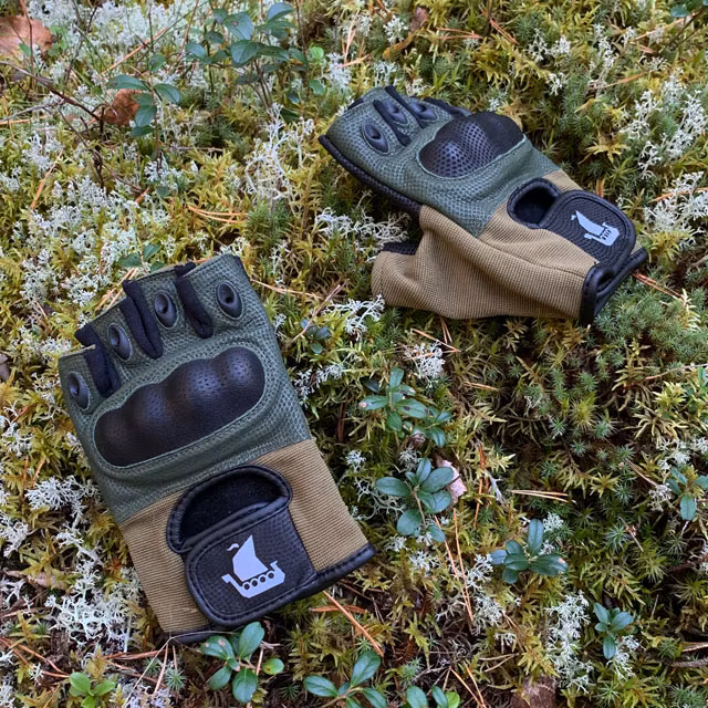 A pair of Short Finger Tactical Glove Green on the forest floor