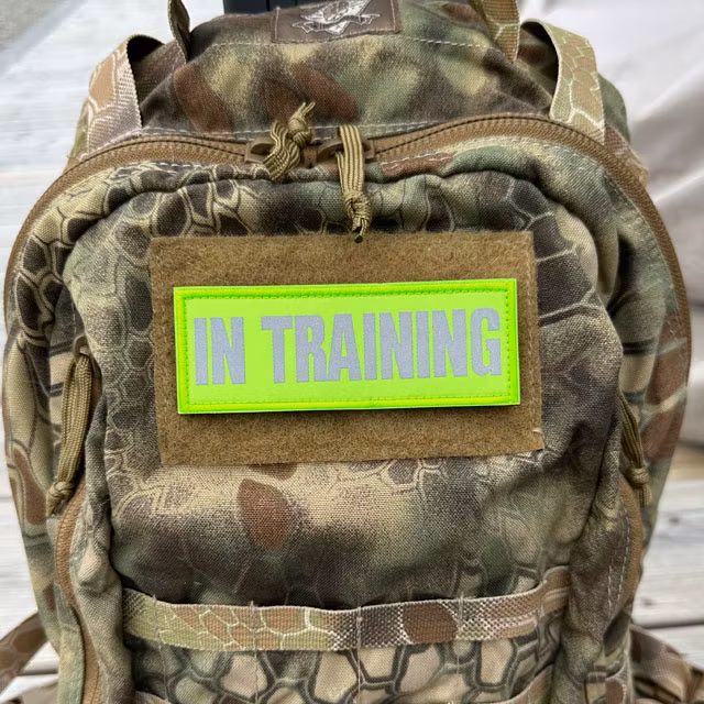 In Training HiVis Patch mounted on a camouflage backpack