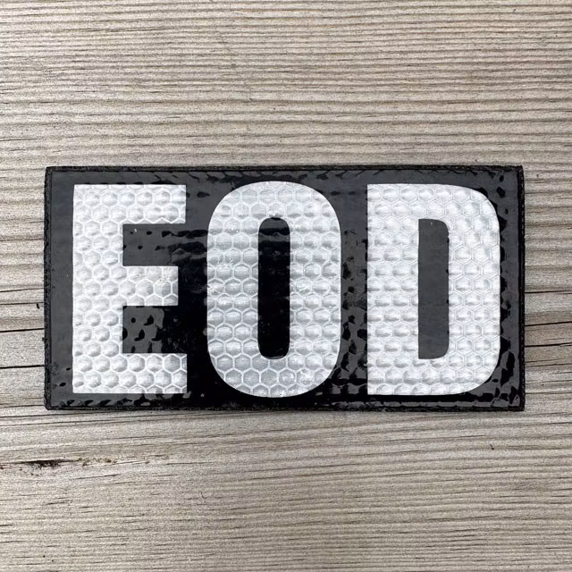 IR EOD Reflective Black & White Hook Patch displayed on a wooden surface