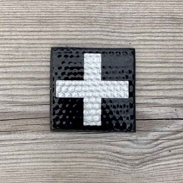 IR MEDIC Reflective Black & White Hook Patch displayed on a wooden surface