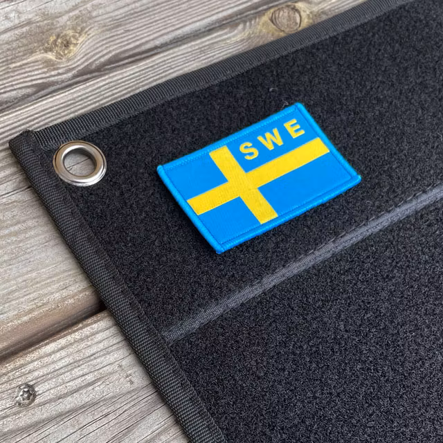Kardborre Wall Mat Display Black Small with a Swedish flag patch on it