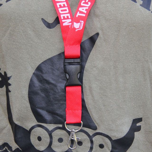 Worn on the neck on a mannequin is the Lanyard Red/White.