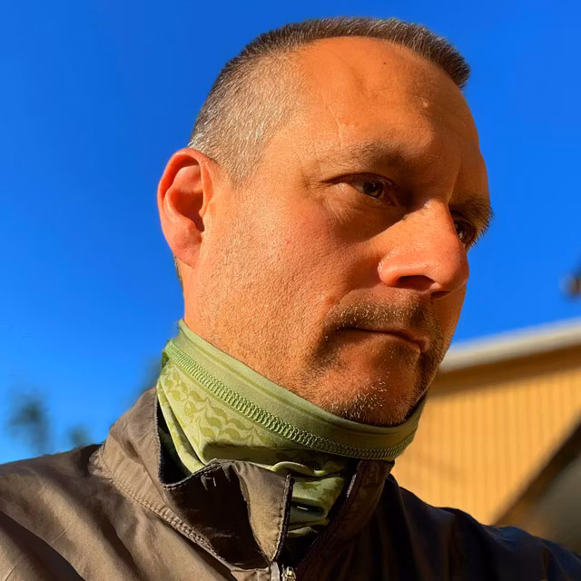 A Neck Tube Shemagh Lime Green from TAC-UP GEAR worn around the neck