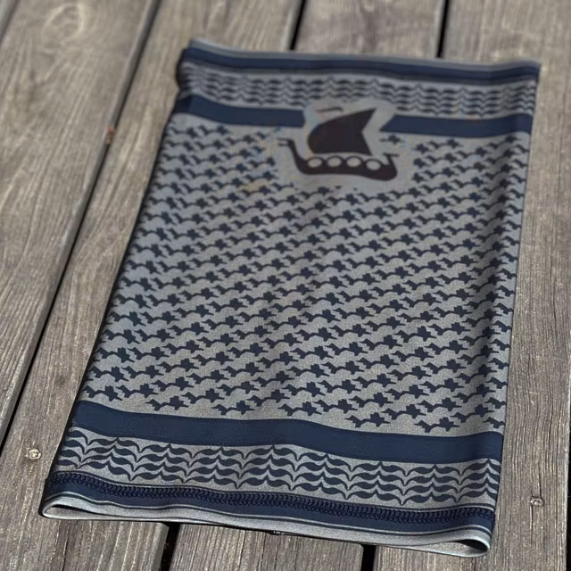 A Neck Tube Shemagh Navy Grey from TAC-UP GEAR lying flat on wooded floor