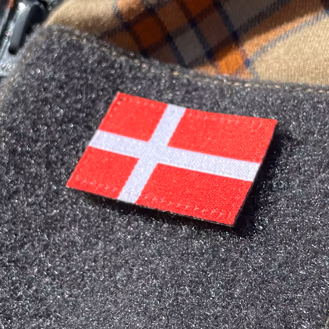 A closer look on a Denmark Flag Hook Patch Small from TAC-UP GEAR mounted on velcro sleeve
