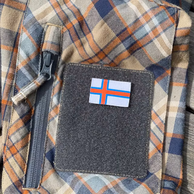 A Faroese Flag Hook Patch Small mounted on a shirt