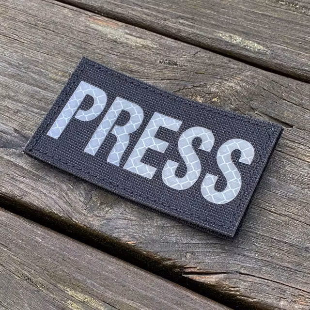 A IR - PRESS White txt Hook Patch seen slight from the side