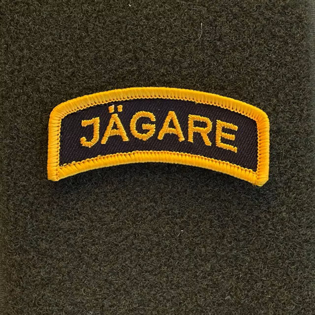 JÄGARE Hook Patch Orange/Black seen from the front mounted on a hook piece