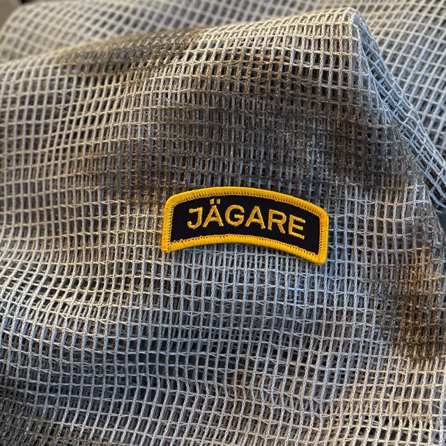 A JÄGARE Hook Patch Orange/Black seenphotoed on a Scrim Scarf