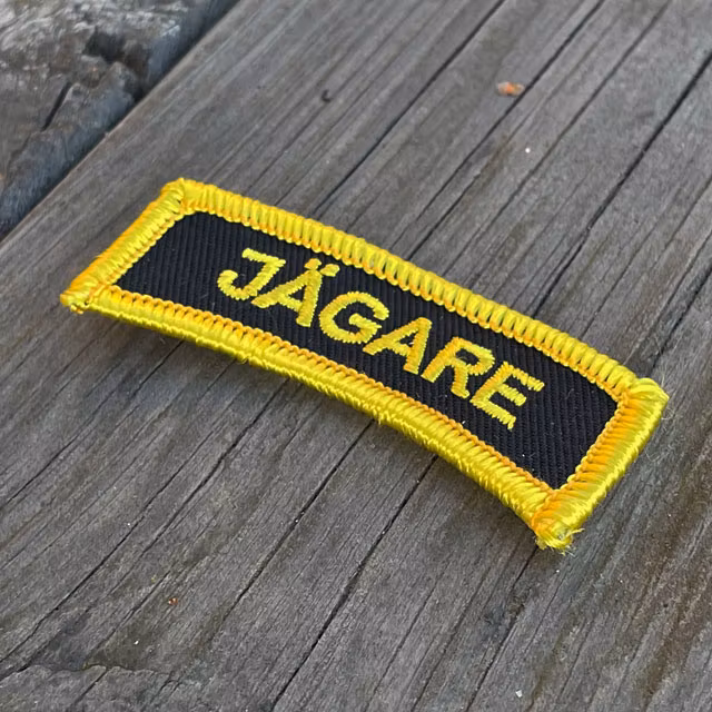 JÄGARE Sew On Patch Yellow/Black/Yellow seen from an angle