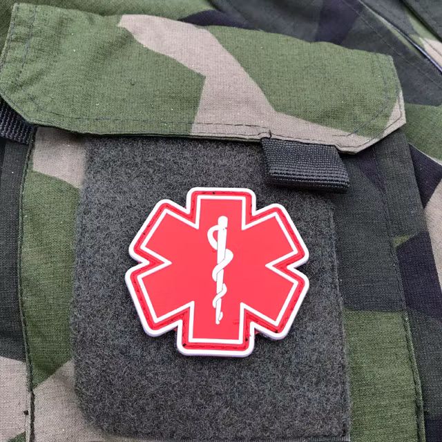 Arm pocket of a NCWR M90 Jacket and a MEDIC PVC Star Red White Hook Patch.