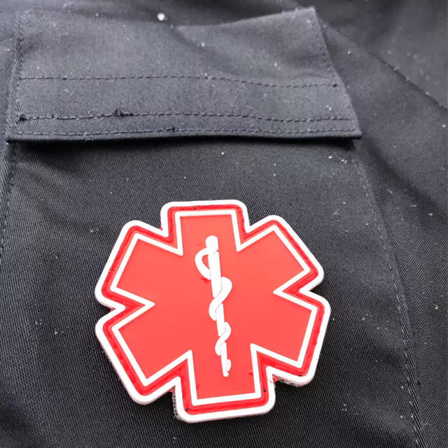 Blue background and a MEDIC PVC Star Red White Hook Patch.