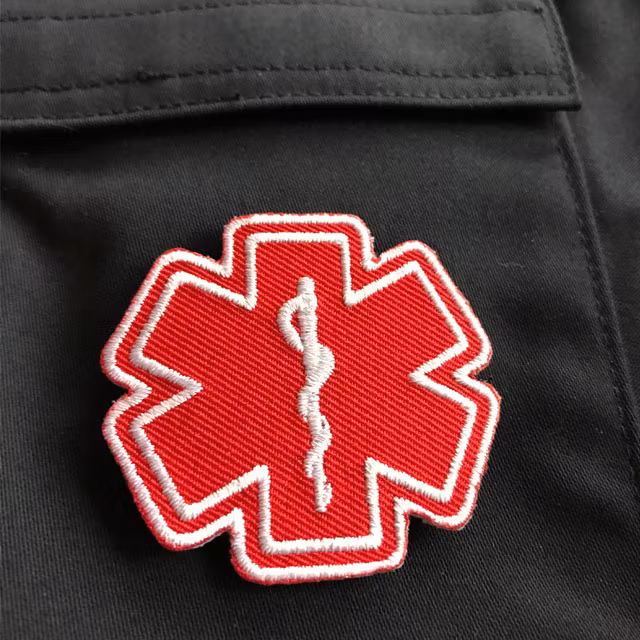 MEDIC Star of Life Red White Hook Patch on blue jacket.