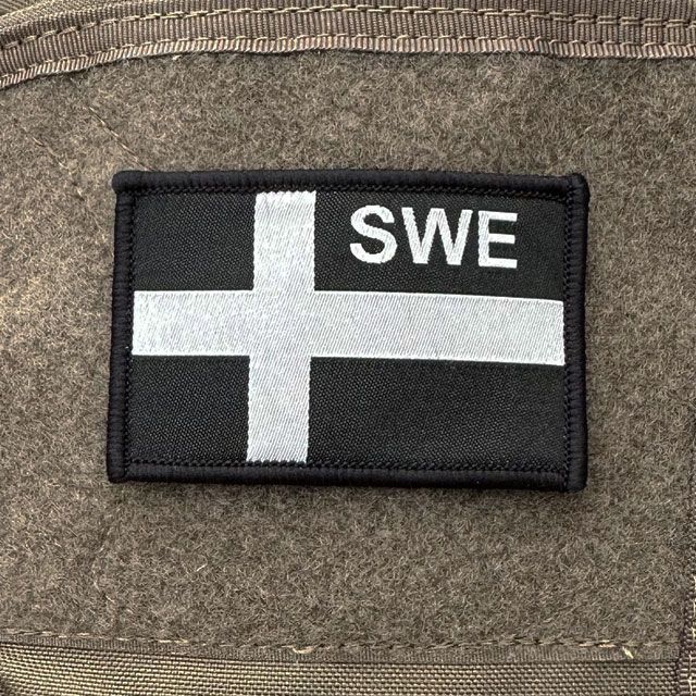 a Sweden Flag OPS Black Grey Patch mounted on a rucksack