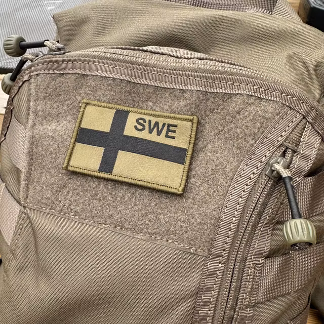 a Sweden Flag OPS Green Black Patch mounted on a rucksack